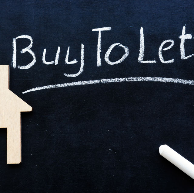 Image showing a "Buy To Let" word written on a black board, next to small wooden house